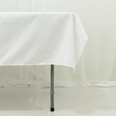White tablecloth draped over a table leg in a studio setting.