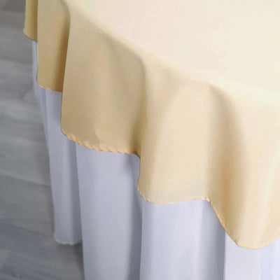 Elegant yellow tablecloth draping over a white table.
