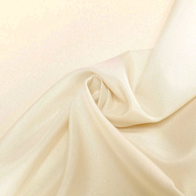 Cream-colored satin fabric with soft draping and sheen. #whtbkgd