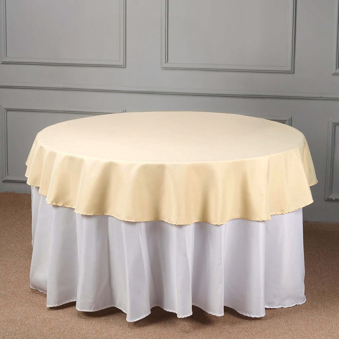 Round table with a yellow and white tablecloth.