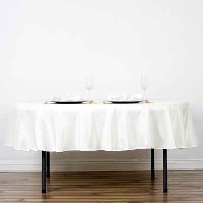 Elegant white tablecloth draped over a table set for dining.