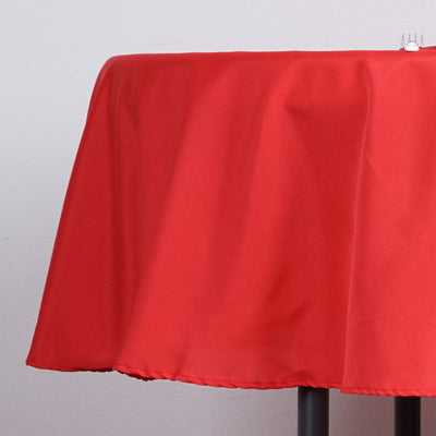 Red tablecloth draping over a table edge.