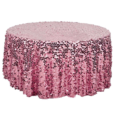 Pink sequin tablecloth with ruffled edges on a round table.