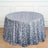 Round silver sequin tablecloth on a wooden surface.