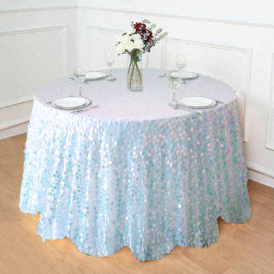 Round sequin tablecloth on a dining table with floral centerpiece and dinnerware.