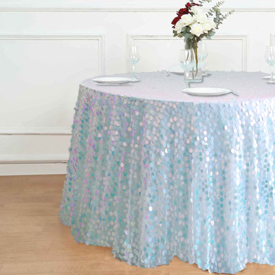 Sequin tablecloth in light blue with iridescent dots on a round table.