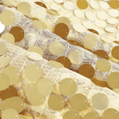 Gold sequin fabric with a textured pattern of circular sequins. #whtbkgd