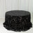 Black sequin tablecloth draped over a round table in a studio setting.