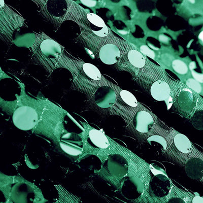 Green sequin fabric with shiny circular embellishments. #whtbkgd