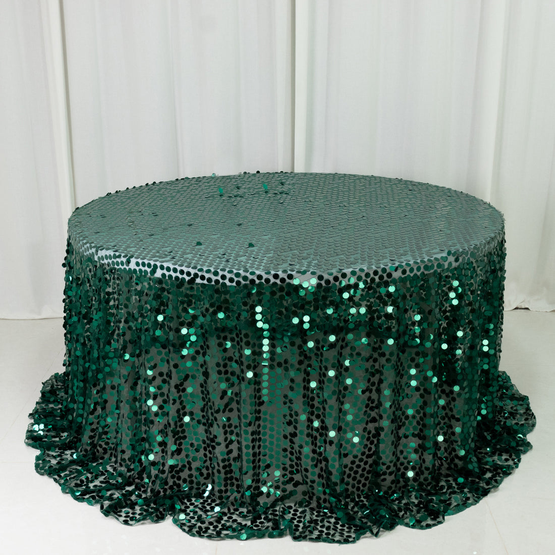 Green sequin tablecloth with cascading sequins for events and parties.