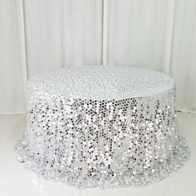 Round silver sequin table cover on a white backdrop.