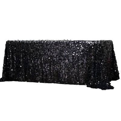 Black sequin tablecloth draped elegantly over a table.