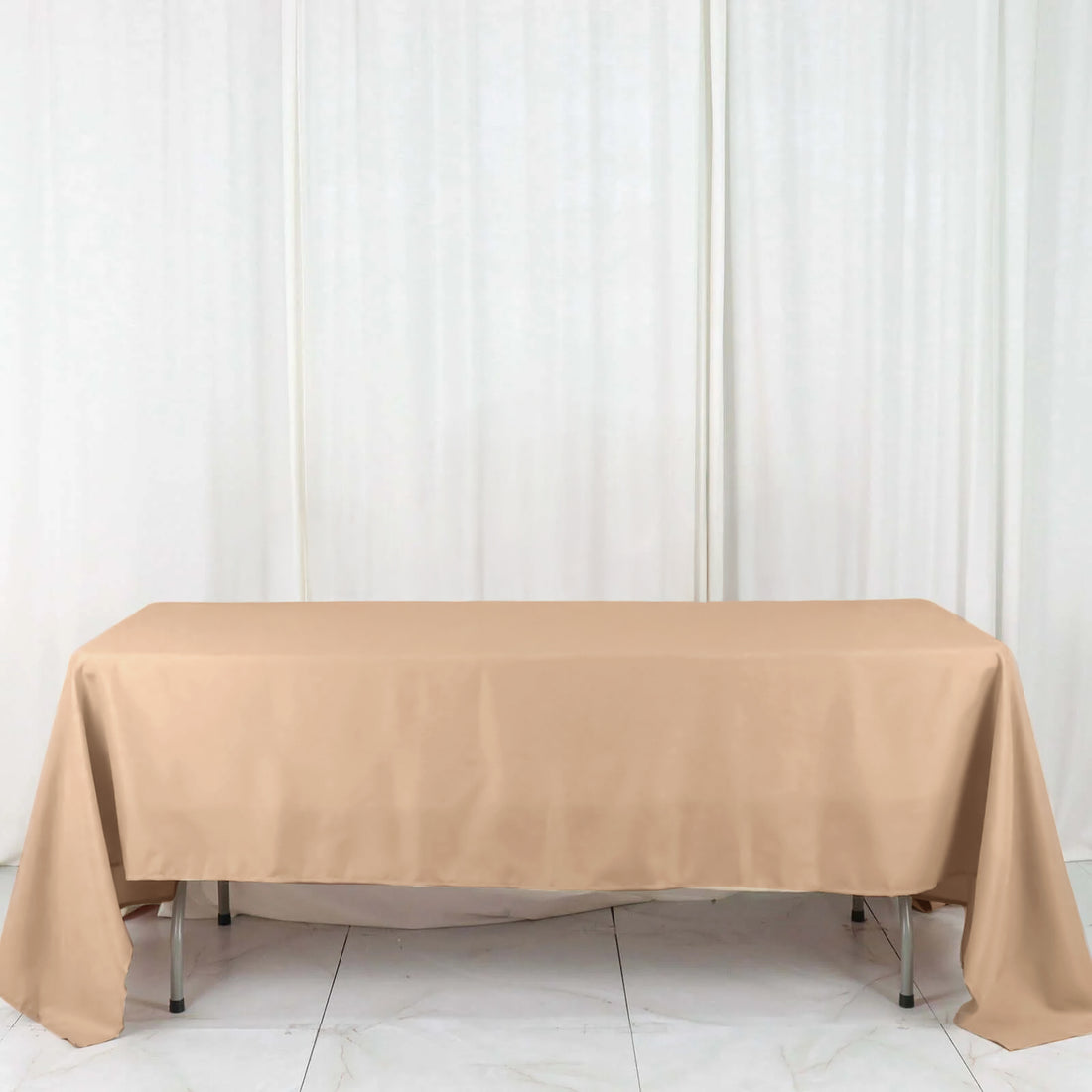 Beige tablecloth on a table against a neutral backdrop
