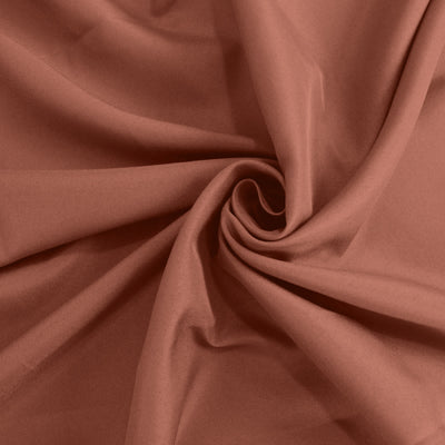 Textured rust fabric swirl, showcasing rich color and softness. #whtbkgd
