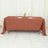 Brown tablecloth draped over a table set with plates and glasses.