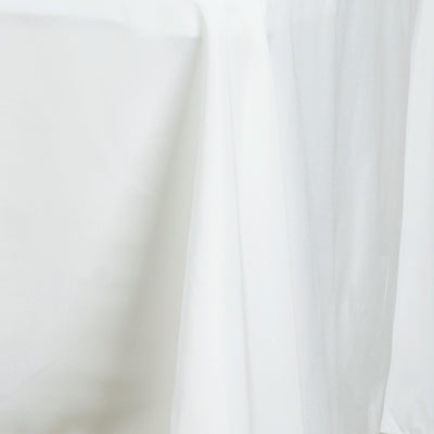White fabric draped elegantly, showcasing soft texture and gentle folds.