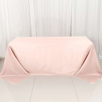 Pink tablecloth draped elegantly over a table in a studio setting.