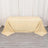Beige tablecloth draped over a table on a neutral backdrop.
