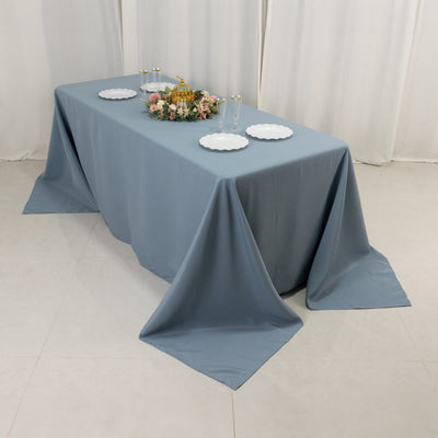 Blue tablecloth draped over a table set for an elegant meal.