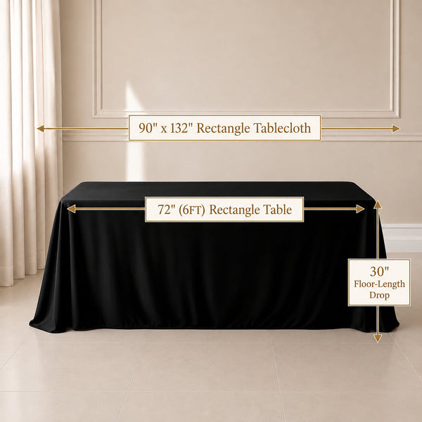 A black rectangular tablecloth draped over a table in a styled interior room, with overlaid dimension labels showing 90 x 132 inch tablecloth size, 72 by 6 foot table length, and 30 inch floor-length drop.