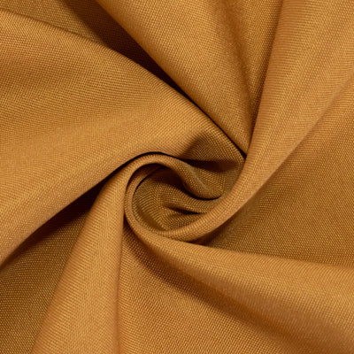 Textured golden fabric close-up showcasing rich color and weave details.