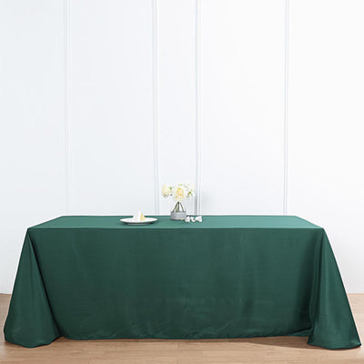 Green tablecloth on a wooden table with decorative elements