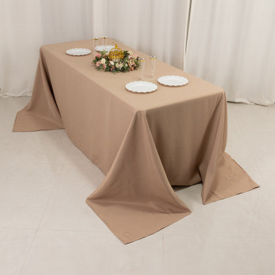 Beige tablecloth draped elegantly over a table set for an event.