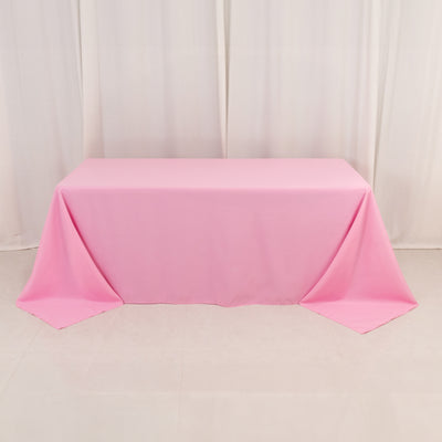 Pink tablecloth draped over a table in a studio setting