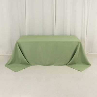 Green tablecloth draped over a table in a studio setting.