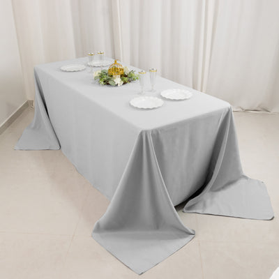 Elegant gray tablecloth draped over a table set for dining.