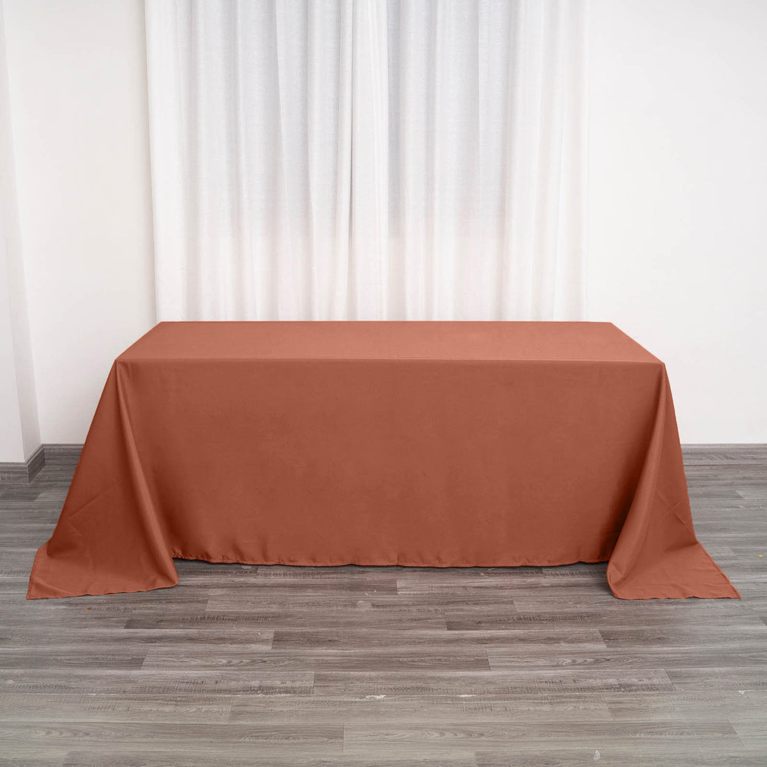 Brown tablecloth draped on a table in a minimalist indoor setting.