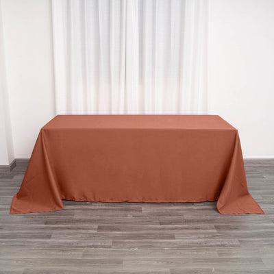 Brown tablecloth draped on a table in a minimalist indoor setting.