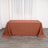 Brown tablecloth draped on a table in a minimalist indoor setting.