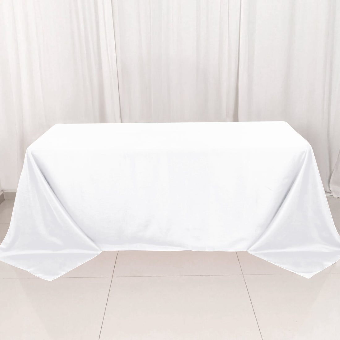 White tablecloth draped over a table in a clean, minimalist setting.