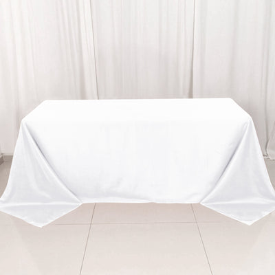 White tablecloth draped over a table in a clean, minimalist setting.