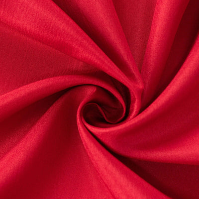 Red fabric texture in a swirling pattern.