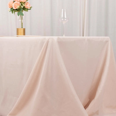 Elegant table setting with a floral centerpiece and wine glass.