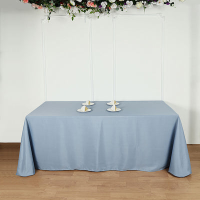 Blue tablecloth draped over a table with candle holders
