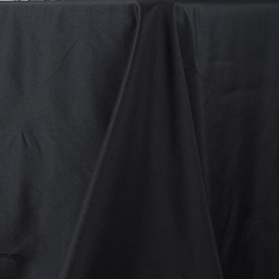 Black fabric draped elegantly on a surface.
