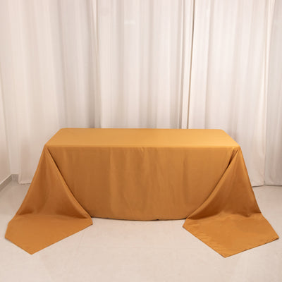 Solid mustard yellow tablecloth draped elegantly over a table.