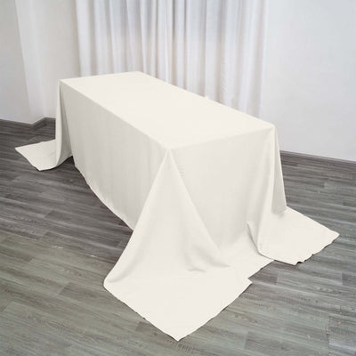 White tablecloth draped over a table in a softly lit environment.