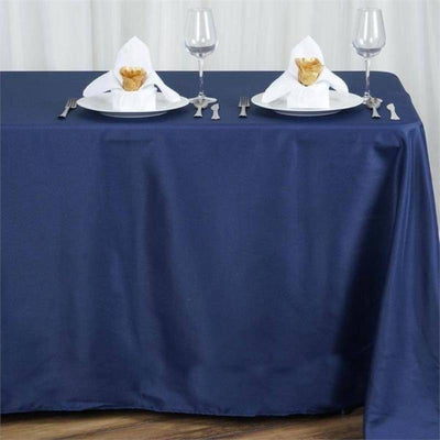 Navy tablecloth set with plates and napkins for elegant dining setup.