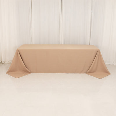 Beige tablecloth draped over a table in a studio setting.