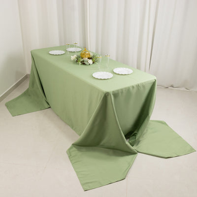 Green tablecloth draped elegantly over a table set for an event.