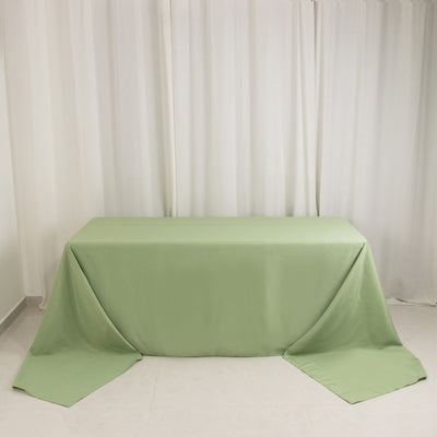 Green tablecloth draped over a table in a minimalistic setting.