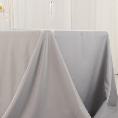 Gray tablecloth elegantly draped over a table in a bright setting.