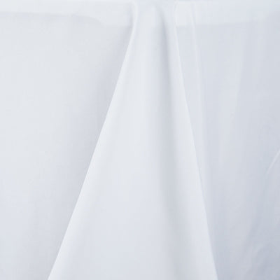 White tablecloth draped elegantly, showcasing smooth fabric texture.