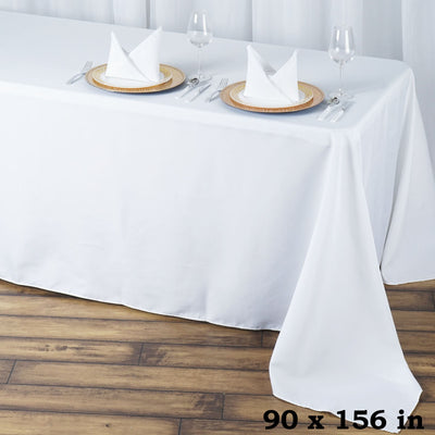 White tablecloth 90 x 156 inches styled with plates and glasses