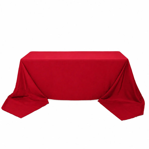 Red tablecloth draped over rectangular table on white background