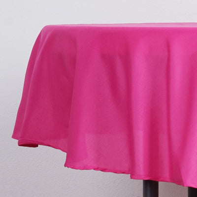 Pink tablecloth draping over a round table edge